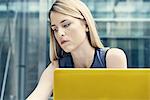 Young businesswoman looking down at office desk