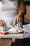 Woman preparing vegetarian dish on cutting board