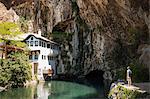 Man looking at Dervish house, Blagaj Japra, Republika Srpska, Bosnia and Herzegovina, Europe