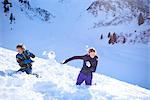 Siblings having snow ball fight, Hintertux, Tirol, Austria