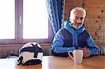 Man taking coffee break in log cabin, Hintertux, Tirol, Austria