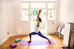 Side view of woman arms raised in yoga position