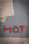 Red chilli peppers arranged to spell the word 'HOT', overhead view