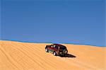 SUV on sand dunes, Erg Awbari, Sahara desert, Fezzan, Libya