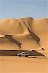 SUV on sand dunes, Erg Awbari, Sahara desert, Fezzan, Libya