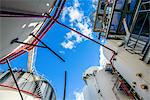 Low angle view of storage tanks and industrial piping at biofuel plant