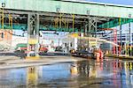Worker pressure hosing biofuel oil tanker cleaning station at biofuel plant