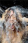 Woman splashing water on face