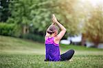 Girl in yoga pose on grass