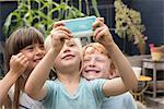 Smiling children taking selfie