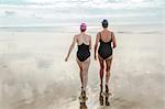 Mother and daughter heading to sea, Folkestone, UK