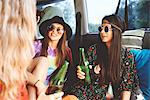 Three young boho women relaxing in recreational van