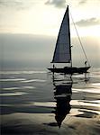 View of sailing boat on the ocean, calm sea.