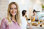 Young woman smiling cheerfully in small business, portrait