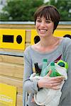 Woman bringing recyclables to recycling center