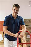 Man working in warehouse, smiling cheerfully, portrait