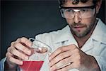 Scientist pouring liquid into test tube in lab