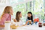 Friends relaxing together at cafe while out shopping