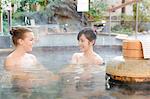 Caucasian woman with Japanese friend bathing at traditional hot spring, Tokyo, Japan