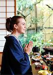 Caucasian woman wearing yukata eating at traditional ryokan, Tokyo, Japan