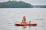 Girl with dog on inflatable boat