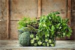 Green vegetables and herbs in wire basket