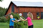 Brother and sister playing ball