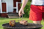 Woman having barbecue