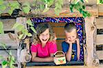 Happy boy and girl in playhouse