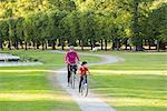 Mother and son cycling in park