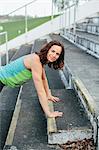 Woman training on stadium benches