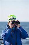 Man looking through binoculars