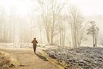 Woman jogging at foggy morning