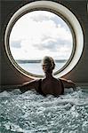 Woman in hot tub looking through window