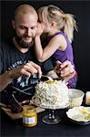 Father and daughter preparing cake