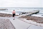 Man walking on promenade on beach