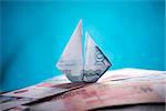 ship origami banknotes on a background of money