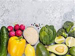 Quinoa and vegetables on gray concrete background. Vegan food ingredients. Colorful food background. Copy space. Top view or flat lay.