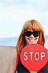 Young woman showing stop sign