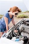 Woman looking at broken engine