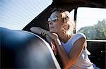 Woman in the back of a car, looking out