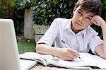 Boy doing homework in garden