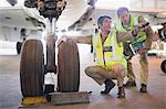 Aircraft workers talking on airfield