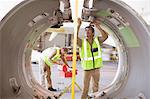 Aircraft workers checking airplane part