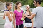 Tennis coach talking to students