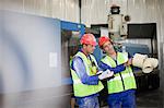 Workers examining product in factory