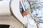 Girl peering out of RV