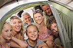 Family peering into camping tent