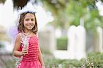 Girl in fairy costume holding flowers