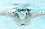 Woman in goggles swimming in pool